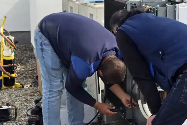 Tecnicos de reparaklima trabajando sistema de climatización comercial